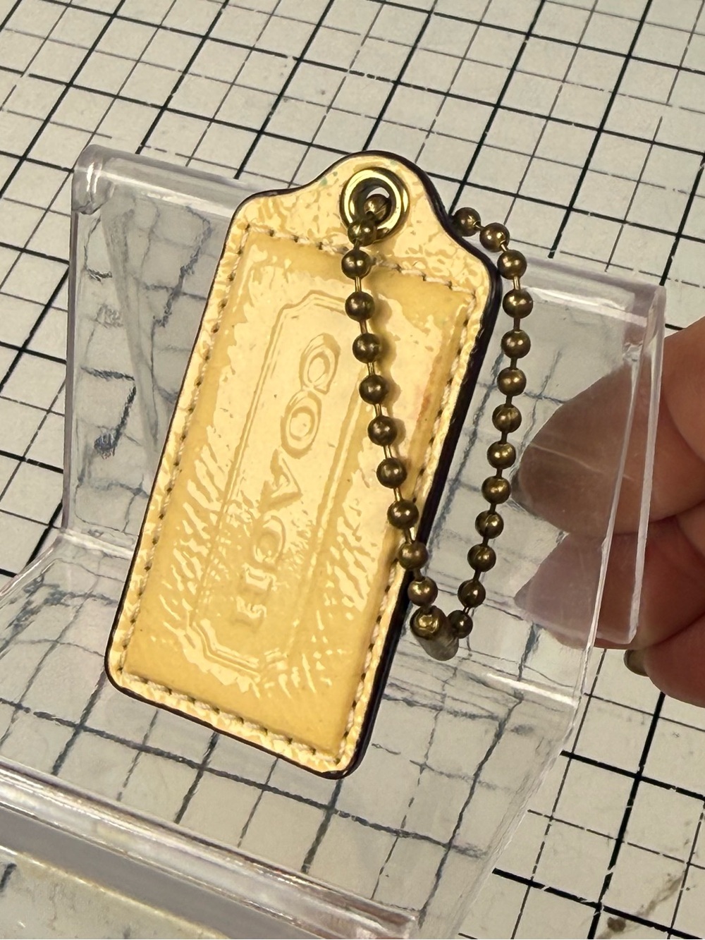 Coach Yellow Patent and cream Leather HangTag with chain. 2.5 by 1.25 in.